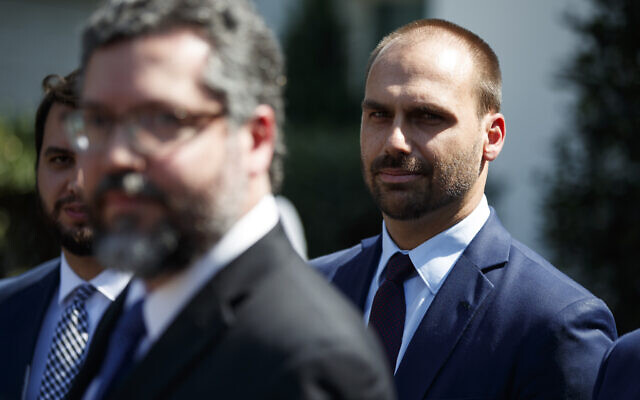 Eduardo Bolsonaro, son of Brazilian President Jair Bolsonaro, right, listens as Brazilian Foreign Minister Ernesto Araujo speaks with reporters after meeting with President Donald Trump at the White House, August 30, 2019, in Washington. (AP Photo/Evan Vucci) Eduardo Bolsonaro, son of Brazilian President Jair Bolsonaro, right, listens as Brazilian Foreign Minister Ernesto Araujo speaks with reporters after meeting with President Donald Trump at the White House, August 30, 2019, in Washington. (AP Photo/Evan Vucci)