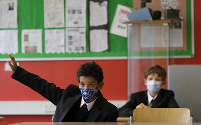 Year seven pupils Henry Holness, left, and Eddie Favell in class during their first day at Kingsdale Foundation School in London, September 3, 2020. (AP Photo/Kirsty Wigglesworth)