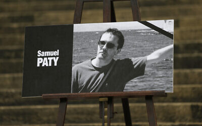 A portrait of slain teacher Samuel Paty with a black ribbon is displayed Oct. 20, 2020 on the steps of the National Assembly in Paris. (AP Photo/Lewis Joly)