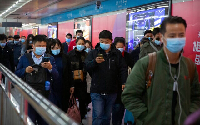 Commuters look at their smartphones as they walk through a subway station in Beijing, Thursday, Oct. 29, 2020. (AP Photo/Mark Schiefelbein) Commuters look at their smartphones as they walk through a subway station in Beijing, Thursday, Oct. 29, 2020. (AP Photo/Mark Schiefelbein)