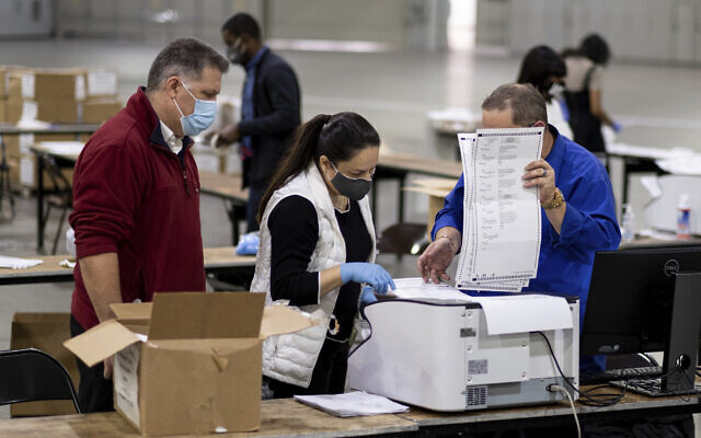 Illustrative: Workers scan ballots as the Fulton County presidential recount gets under way, November 25, 2020 at the Georgia World Congress Center in Atlanta. (AP Photo/Ben Gray) Illustrative: Workers scan ballots as the Fulton County presidential recount gets under way, November 25, 2020 at the Georgia World Congress Center in Atlanta. (AP Photo/Ben Gray)
