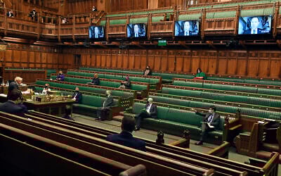 In this handout photo provided by UK Parliament, then-UK prime minister Boris Johnson, left, speaks during Prime Minister's Questions in the House of Commons in London, on February 10, 2021. (Jessica Taylor/ UK Parliament via AP/ File)