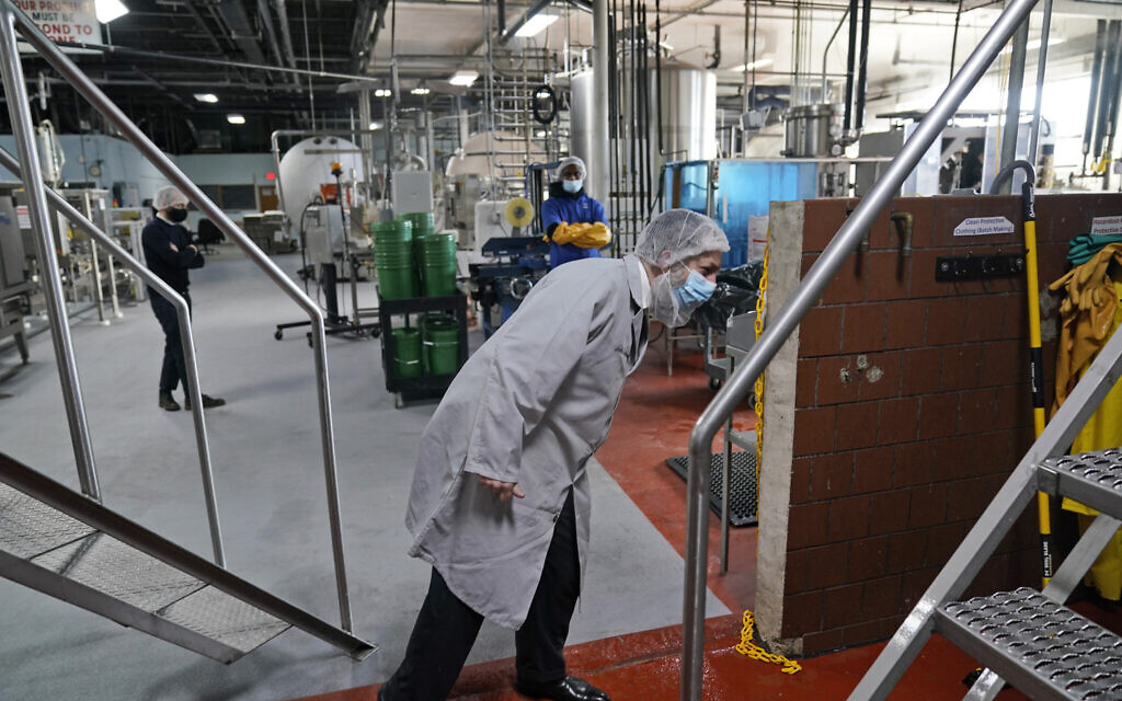 Rabbi Joseph Schwartz inspects some machinery as he supervises the koshering for Hanan Products' kosher-for-passover production run on Jan. 7, 2021, in Hicksville, N.Y. (AP/Seth Wenig)
