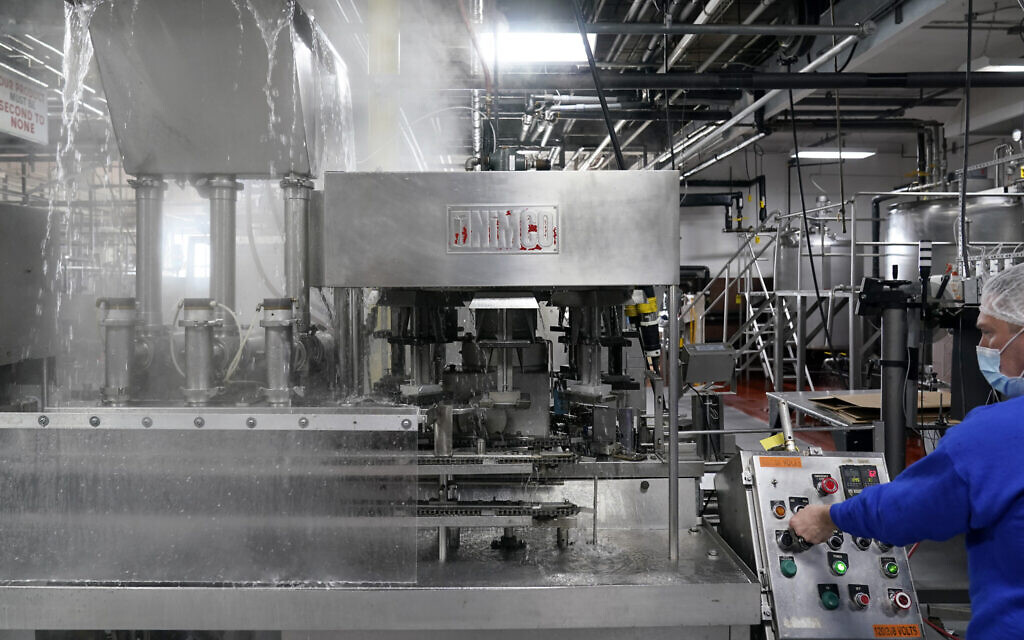 Foreman Dave Garthe runs boiling water through and over machinery in preparation for Hanan Products kosher-for-Passover production run, Thursday, Jan. 7, 2021, in Hicksville, N.Y. (AP/Seth Wenig)
