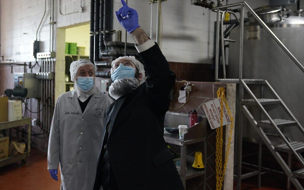 Rabbis Joseph Schwartz, left, and Mendel Einhorn confer as they supervise Hanan Products preparations for their kosher-for-Passover production run on Jan. 7, 2021, in Hicksville, N.Y. (AP Photo/Seth Wenig)