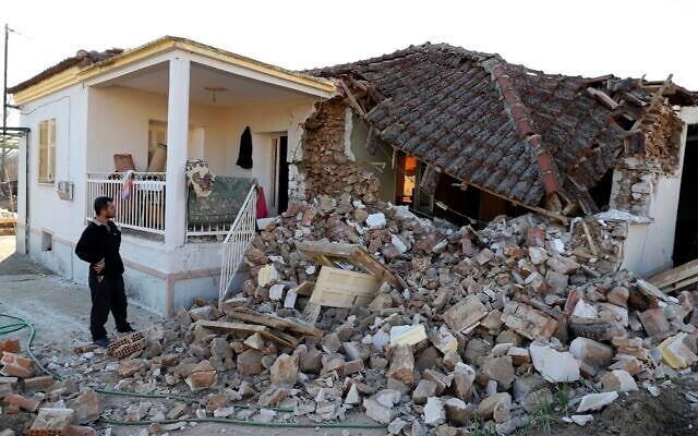 A man stands next to a damaged house after an earthquake in Mesochori village, central Greece, Wednesday, March 3, 2021. An earthquake with a preliminary magnitude of at least 6.0 struck central Greece Wednesday and was also felt in neighboring Albania and North Macedonia, and as far as Kosovo and Montenegro. (AP Photo/Vaggelis Kousioras) A man stands next to a damaged house after an earthquake in Mesochori village, central Greece, Wednesday, March 3, 2021. An earthquake with a preliminary magnitude of at least 6.0 struck central Greece Wednesday and was also felt in neighboring Albania and North Macedonia, and as far as Kosovo and Montenegro. (AP Photo/Vaggelis Kousioras)