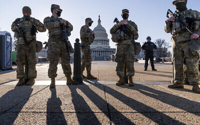 Members of the Michigan National Guard and the US Capitol Police keep watch as heightened security remains in effect around the Capitol grounds since the Jan. 6 attacks by a mob of supporters of then-President Donald Trump, in Washington, Wednesday, March 3, 2021. The US Capitol Police say they have intelligence showing there is a "possible plot" by a militia group to breach the Capitol on Thursday. (AP Photo/J. Scott Applewhite)