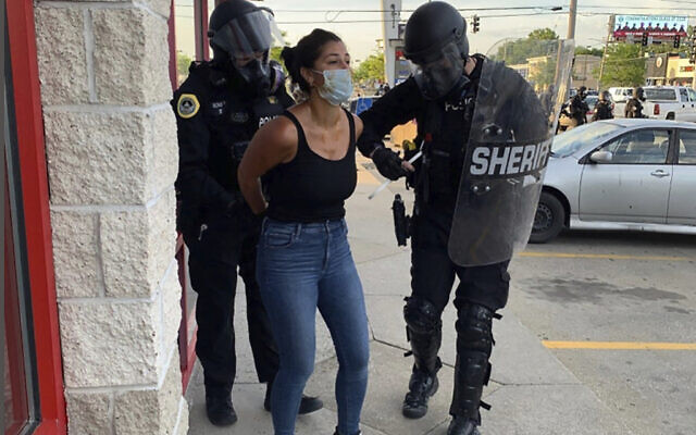 Police officers are shown arresting Des Moines Register reporter Andrea Sahouri after a Black Lives Matter protest she was covering on May 31, 2020, in Des Moines, Iowa, was dispersed by tear gas. (Katie Akin via AP) Police officers are shown arresting Des Moines Register reporter Andrea Sahouri after a Black Lives Matter protest she was covering on May 31, 2020, in Des Moines, Iowa, was dispersed by tear gas. (Katie Akin via AP)
