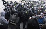 In this Jan. 6, 2021, file photo, US Capitol Police push back rioters trying to enter the US Capitol in Washington. A former State Department aide in President Donald Trump’s administration has been charged with participating in the deadly siege at the Capitol. Court papers say Federico Klein was seen wearing a 'Make America Great Again' hat amid the throng of people trying to force their way into the Capitol. (AP Photo/Jose Luis Magana, File)