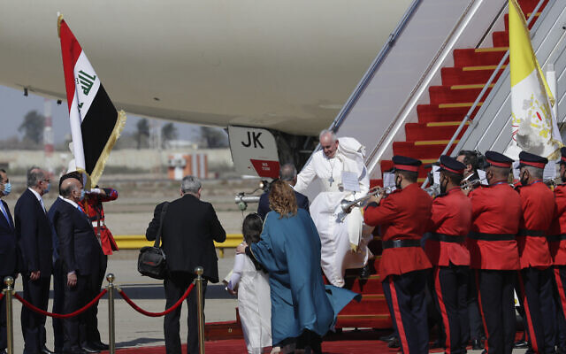 Pope Francis arrives at Baghdad's international airport, Iraq, Friday, March 5, 2021. Pope Francis heads to Iraq on Friday to urge the country's dwindling number of Christians to stay put and help rebuild the country after years of war and persecution, brushing aside the coronavirus pandemic and security concerns. (AP Photo/Andrew Medichini) Pope Francis arrives at Baghdad's international airport, Iraq, Friday, March 5, 2021. Pope Francis heads to Iraq on Friday to urge the country's dwindling number of Christians to stay put and help rebuild the country after years of war and persecution, brushing aside the coronavirus pandemic and security concerns. (AP Photo/Andrew Medichini)