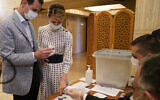 This file photo released July 19, 2020, on the official Facebook page of the Syrian Presidency shows Syrian President Bashar Assad, left, and his wife Asma voting at a polling station in the parliamentary elections, in Damascus, Syria. (Syrian Presidency via AP)