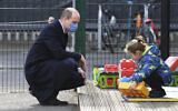 Britain's Prince William watches a child in the playground during a visit with Kate, Duchess of Cambridge, to School21, a school in east London, March 11, 2021. (Justin Tallis/Pool via AP)