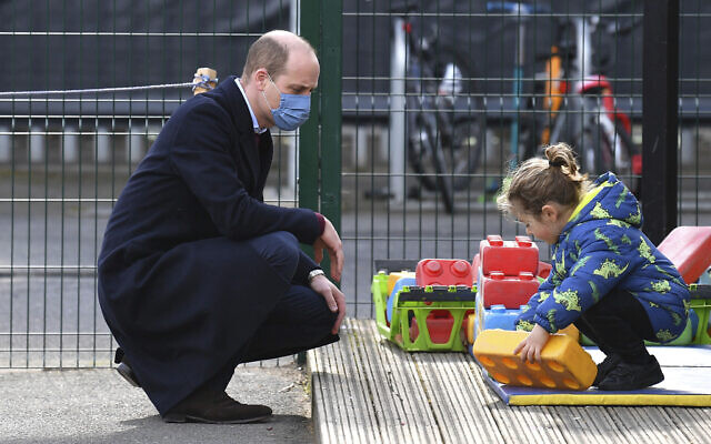 Britain's Prince William watches a child in the playground during a visit with Kate, Duchess of Cambridge, to School21, a school in east London, March 11, 2021. (Justin Tallis/Pool via AP) Britain's Prince William watches a child in the playground during a visit with Kate, Duchess of Cambridge, to School21, a school in east London, March 11, 2021. (Justin Tallis/Pool via AP)