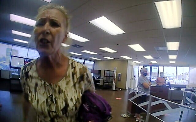 This frame grab from police body cam video provided by the Galveston Police Department, in Galveston, Texas, shows Terry Wright, 65, of Grants Pass, Oregon, arguing with an officer inside a Bank of America branch, in Galveston, March 11, 2021, (Galveston Police Department via AP) This frame grab from police body cam video provided by the Galveston Police Department, in Galveston, Texas, shows Terry Wright, 65, of Grants Pass, Oregon, arguing with an officer inside a Bank of America branch, in Galveston, March 11, 2021, (Galveston Police Department via AP)