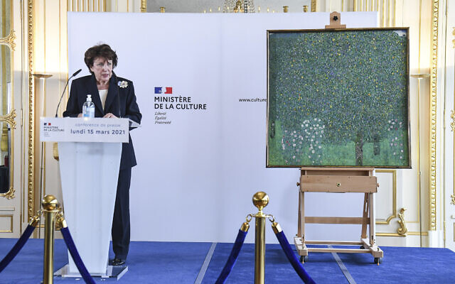 French Culture Minister Roselyne Bachelot poses next to an oil painting by Gustav Klimt painted in 1905 called 'Rosebushes under the Trees,' during a ceremony at the Orsay museum in Paris, March 15, 2021. (Alain Jocard/Pool Photo via AP) French Culture Minister Roselyne Bachelot poses next to an oil painting by Gustav Klimt painted in 1905 called 'Rosebushes under the Trees,' during a ceremony at the Orsay museum in Paris, March 15, 2021. (Alain Jocard/Pool Photo via AP)