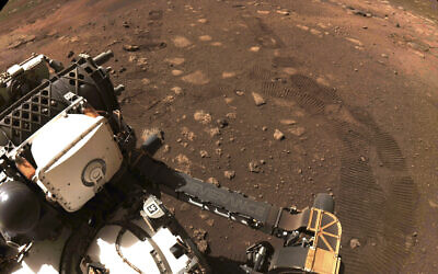 This March 4, 2021 file photo made available by NASA was taken during the first drive of the Perseverance rover on Mars. The Perseverance rover has been on Mars for a month, collecting data and making discoveries with each passing day. (NASA/JPL-Caltech via AP)