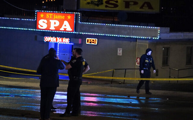 Law enforcement officials confer outside a massage parlor following a shooting on March 16, 2021, in Atlanta. (AP Photo/Brynn Anderson) Law enforcement officials confer outside a massage parlor following a shooting on March 16, 2021, in Atlanta. (AP Photo/Brynn Anderson)