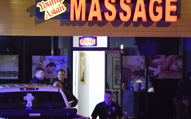 Authorities investigate a fatal shooting at a massage parlor, late Tuesday, March 16, 2021, in Woodstock, Ga. Officials say 21-year-old Robert Aaron Long, of Woodstock, Georgia, has been captured hours after multiple people were killed in shootings at three Atlanta-area massage parlors. (AP Photo/Mike Stewart) Authorities investigate a fatal shooting at a massage parlor, late Tuesday, March 16, 2021, in Woodstock, Ga. Officials say 21-year-old Robert Aaron Long, of Woodstock, Georgia, has been captured hours after multiple people were killed in shootings at three Atlanta-area massage parlors. (AP Photo/Mike Stewart)
