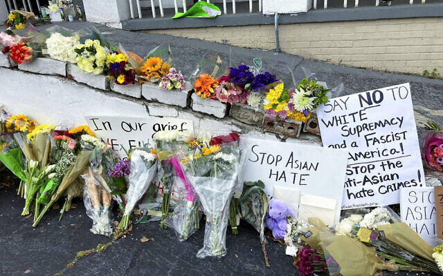 On March 19, 2021, flowers, candles and signs are displayed at a makeshift memorial in Atlanta. A deadly rampage at three Georgia massage businesses, where the employees were mostly of Asian descent, has prompted Asian American women to openly share stories of being sexually harassed or demeaned based on their race. (AP Photo/Candice Choi, File) On March 19, 2021, flowers, candles and signs are displayed at a makeshift memorial in Atlanta. A deadly rampage at three Georgia massage businesses, where the employees were mostly of Asian descent, has prompted Asian American women to openly share stories of being sexually harassed or demeaned based on their race. (AP Photo/Candice Choi, File)
