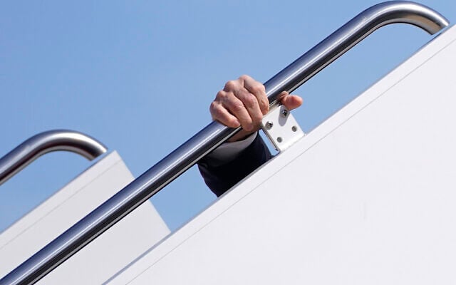 US President Joe Biden holds onto the hand rail as he stumbles while boarding Air Force One at Andrews Air Force Base, Md., Friday, March 19, 2021. Biden is en route to Georgia. (AP Photo/Patrick Semansky) US President Joe Biden holds onto the hand rail as he stumbles while boarding Air Force One at Andrews Air Force Base, Md., Friday, March 19, 2021. Biden is en route to Georgia. (AP Photo/Patrick Semansky)
