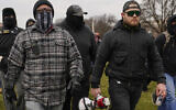 In this Jan. 6, 2021, file photo, Proud Boy members Joseph Biggs, left, and Ethan Nordean, right with megaphone, walk toward the US Capitol in Washington, in support of President Donald Trump. (AP Photo/Carolyn Kaster, File)