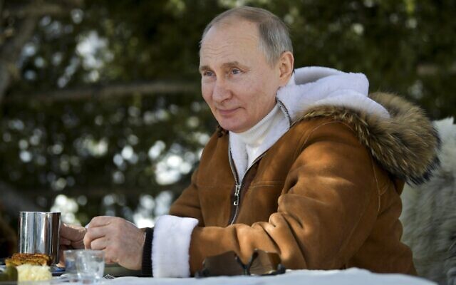 In this photo made available on March 21, 2021, Russian President Vladimir Putin drinks during a break in a taiga forest in Russia's Siberian region. (Alexei Druzhinin, Sputnik, Kremlin Pool Photo via AP) In this photo made available on March 21, 2021, Russian President Vladimir Putin drinks during a break in a taiga forest in Russia's Siberian region. (Alexei Druzhinin, Sputnik, Kremlin Pool Photo via AP)