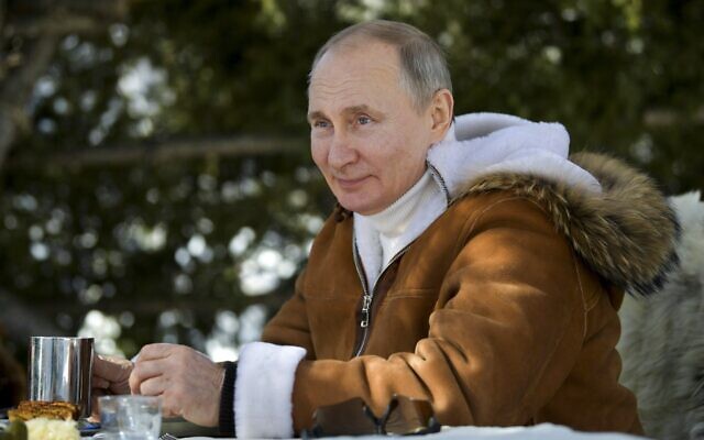 Russian President Vladimir Putin drinks during a break in a taiga forest in Russia's Siberian region in Russia, March 21, 2021. (Alexei Druzhinin, Sputnik, Kremlin Pool Photo via AP) Russian President Vladimir Putin drinks during a break in a taiga forest in Russia's Siberian region in Russia, March 21, 2021. (Alexei Druzhinin, Sputnik, Kremlin Pool Photo via AP)