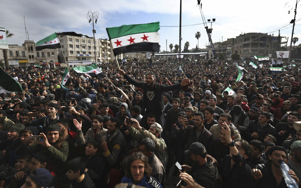Thousands of anti-Syrian government protesters shout slogans and wave revolutionary flags, to mark 10 years since the start of a popular uprising against President Bashar Assad's rule, in Idlib, the last major opposition-held area of the country, in northwest Syria, March 15, 2021. (Ghaith Alsayed/AP) Thousands of anti-Syrian government protesters shout slogans and wave revolutionary flags, to mark 10 years since the start of a popular uprising against President Bashar Assad's rule, in Idlib, the last major opposition-held area of the country, in northwest Syria, March 15, 2021. (Ghaith Alsayed/AP)