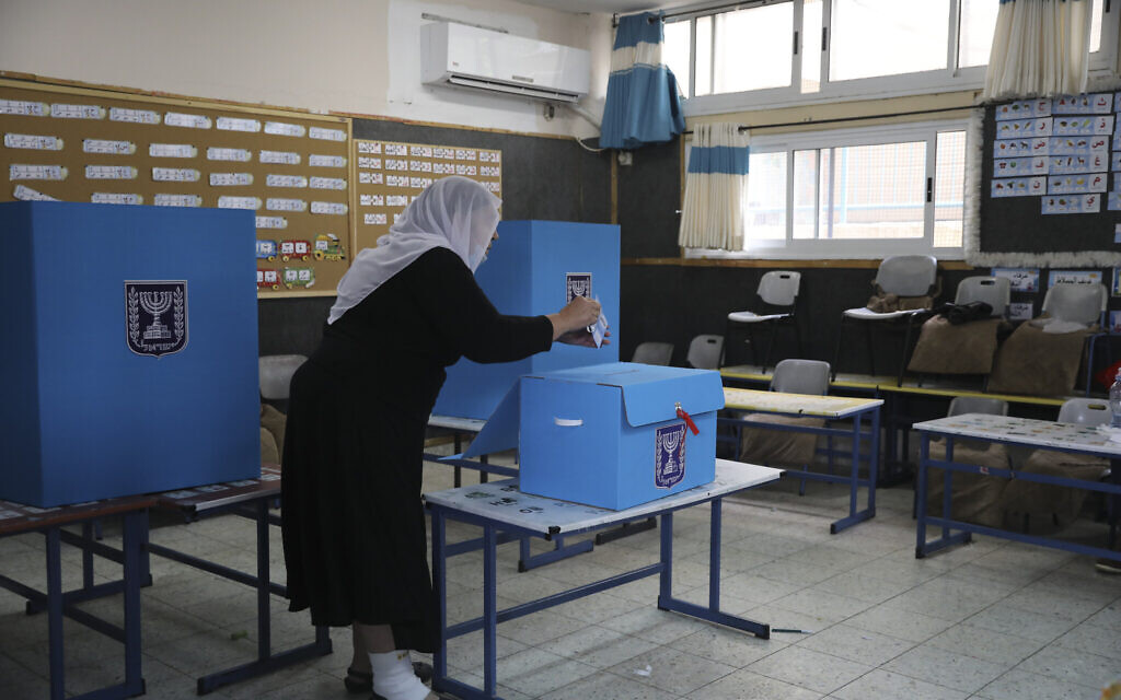 An Arab Israeli woman votes in the Knesset election at a polling station in Maghar, March 23, 2021. (AP Photo/Mahmoud Illean)