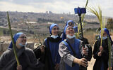 Nuns pose for a selfie as they mark Palm Sunday on the Mount of Olives in Jerusalem, March 28, 2021. (AP Photo/ Mahmoud Illean)