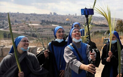 Nuns pose for a selfie as they mark Palm Sunday on the Mount of Olives in Jerusalem, March 28, 2021. (AP Photo/ Mahmoud Illean)