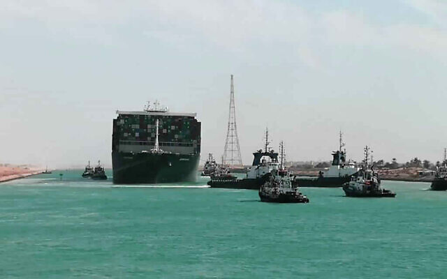 In this photo released by Suez Canal Authority, the Ever Given, a Panama-flagged cargo ship is accompanied by Suez Canal tugboats as it moves in the Suez Canal, Egypt, Monday, March 29, 2021. (Suez Canal Authority via AP) In this photo released by Suez Canal Authority, the Ever Given, a Panama-flagged cargo ship is accompanied by Suez Canal tugboats as it moves in the Suez Canal, Egypt, Monday, March 29, 2021. (Suez Canal Authority via AP)