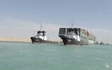 In this photo released by Suez Canal Authority, the Ever Given, a Panama-flagged cargo ship is accompanied by Suez Canal tugboats as it moves in the Suez Canal, Egypt, March 29, 2021. (Suez Canal Authority via AP)