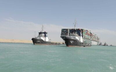 In this photo released by Suez Canal Authority, the Ever Given, a Panama-flagged cargo ship is accompanied by Suez Canal tugboats as it moves in the Suez Canal, Egypt, March 29, 2021. (Suez Canal Authority via AP)