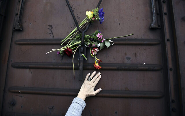 A woman places flowers on a train wagon at the old train station in Thessaloniki, Greece, on the 74th anniversary of the roundup and deportation of its Jews to Nazi extermination camps during World War II, March 19, 2017. (Giannis Papanikos/AP) A woman places flowers on a train wagon at the old train station in Thessaloniki, Greece, on the 74th anniversary of the roundup and deportation of its Jews to Nazi extermination camps during World War II, March 19, 2017. (Giannis Papanikos/AP)