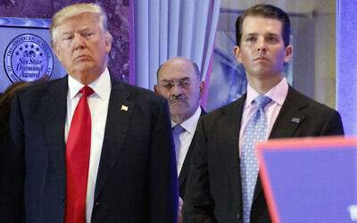 In this Jan. 11, 2017 file photo, Allen Weisselberg, center, is seen between President-elect Donald Trump, left, and Donald Trump Jr., at a news conference in the lobby of Trump Tower in New York.  (AP Photo/Evan Vucci, File)