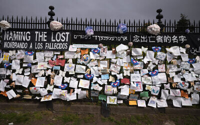 A fence outside Brooklyn's Green-Wood Cemetery is adorned with tributes to victims of COVID-19 in New York,  May 28, 2020. (Mark Lennihan/AP)