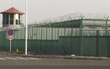 A guard tower and barbed wire fence surround a detention facility in the Kunshan Industrial Park in Artux in western China's Xinjiang region. AP found that the Chinese government was carrying out a birth control program aimed at Uighurs, Kazakhs and other largely Muslim minorities in Xinjiang, even as some of the country's Han majority was encouraged to have more children. The measures included detention in prisons and camps, such as this facility in Artux, as punishment for having too many children, Dec. 3, 2018. (AP Photo/Ng Han Guan, File)