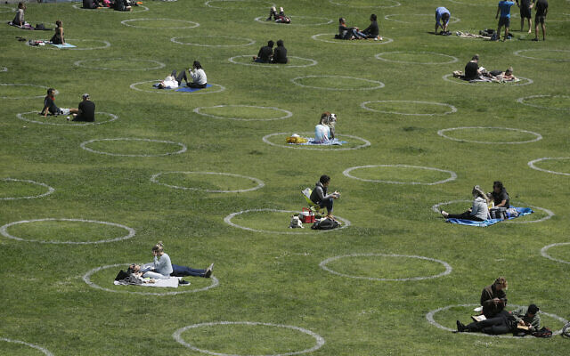 Visitors set up inside circles designed to help prevent the spread of the coronavirus by encouraging social distancing, at Dolores Park in San Francisco, June 28, 2020. (AP Photo/Jeff Chiu) Visitors set up inside circles designed to help prevent the spread of the coronavirus by encouraging social distancing, at Dolores Park in San Francisco, June 28, 2020. (AP Photo/Jeff Chiu)