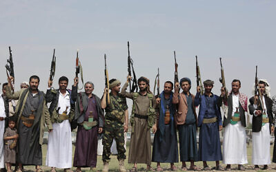 Illustrative: Tribesmen loyal to Houthi rebels raise their weapons during a gathering against the agreement to establish diplomatic relations between Israel and the United Arab Emirates in Sanaa, Yemen, Saturday, Aug. 22, 2020. (AP Photo/Hani Mohammed)