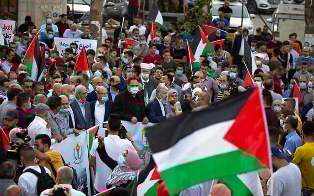 Palestinians wave national flags during a protest against normalization of ties between the United Arab Emirates and Bahrain with Israel, in the West Bank city of Ramallah, September 15, 2020. (Majdi Mohammed/AP) Palestinians wave national flags during a protest against normalization of ties between the United Arab Emirates and Bahrain with Israel, in the West Bank city of Ramallah, September 15, 2020. (Majdi Mohammed/AP)