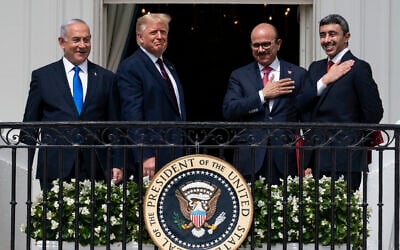 Then-prime minister Benjamin Netanyahu, left, then-US president Donald Trump, Bahrain Foreign Minister Khalid bin Ahmed Al Khalifa and United Arab Emirates Foreign Minister Abdullah bin Zayed al-Nahyan react on the Blue Room Balcony after signing the Abraham Accords during a ceremony on the South Lawn of the White House in Washington, September 15, 2020. (AP Photo/Alex Brandon)