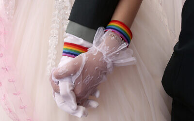Illustrative: Lesbian couples Chen Ying-hsuan, right, holds Li Li-chen's hand during a military mass weddings ceremony in Taoyuan city, northern Taiwan on Oct. 30, 2020. (AP Photo/Chiang Ying-ying) Illustrative: Lesbian couples Chen Ying-hsuan, right, holds Li Li-chen's hand during a military mass weddings ceremony in Taoyuan city, northern Taiwan on Oct. 30, 2020. (AP Photo/Chiang Ying-ying)