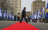 Illustrative: A Kosovo police officer walks across a red carpet prior to a ceremony held digitally, in the capital Pristina, Monday, Feb. 1, 2021. Kosovo and Israel formally have established diplomatic ties in a ceremony held digitally due to the pandemic lockdown. (AP Photo/Visar Kryeziu)