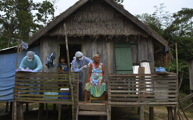 Maria Castro de Lima, 72, receives a dose of the Oxford-AstraZeneca COVID-19 vaccine from a healthcare worker, while sitting on the porch of her home in the Recanto community, along the Purus River, in the Labrea municipality, Amazonas state, Brazil, Feb. 12, 2021. (AP Photo/Edmar Barros) Maria Castro de Lima, 72, receives a dose of the Oxford-AstraZeneca COVID-19 vaccine from a healthcare worker, while sitting on the porch of her home in the Recanto community, along the Purus River, in the Labrea municipality, Amazonas state, Brazil, Feb. 12, 2021. (AP Photo/Edmar Barros)
