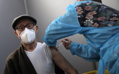 Illustrative: A man receives Pfizer's COVID-19 vaccine at a vaccination site in Paris on March 6, 2021. (AP/Christophe Ena)