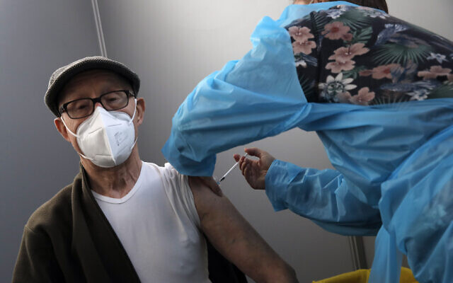 Illustrative: A man receives Pfizer's COVID-19 vaccine at a vaccination site in Paris on March 6, 2021. (AP/Christophe Ena)