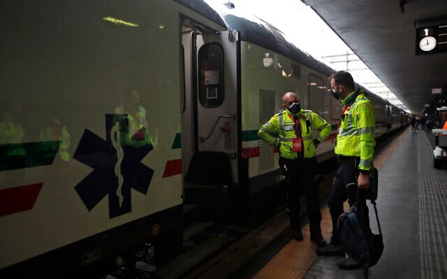 Medical personnel stand outside a train adapted to treat patients, unveiled to the press in Rome Termini central station, March 8, 2021. The health train allows patients to be transferred and treated in eight carriages equipped with specific equipment, including intensive care spaces. (AP Photo/Alessandra Tarantino) Medical personnel stand outside a train adapted to treat patients, unveiled to the press in Rome Termini central station, March 8, 2021. The health train allows patients to be transferred and treated in eight carriages equipped with specific equipment, including intensive care spaces. (AP Photo/Alessandra Tarantino)