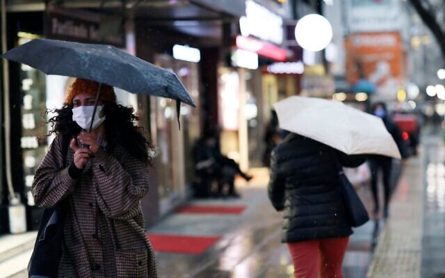 A woman wearing a mask to protect against the spread of coronavirus walks in the rain, in Ankara, Turkey, Tuesday, March 16, 2021 (AP Photo/Burhan Ozbilici) A woman wearing a mask to protect against the spread of coronavirus walks in the rain, in Ankara, Turkey, Tuesday, March 16, 2021 (AP Photo/Burhan Ozbilici)