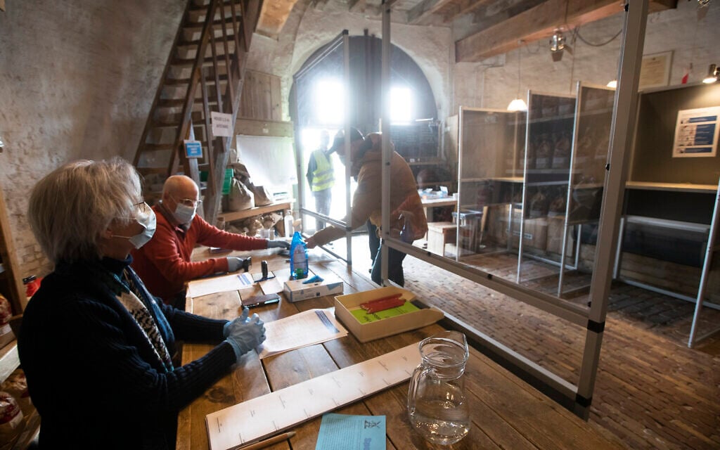 Voters respect social distancing when casting their ballot at windmill the Kerhovense Molen in a general election in Oisterwijk, Netherlands, March 17, 2021. (AP Photo/Peter Dejong)